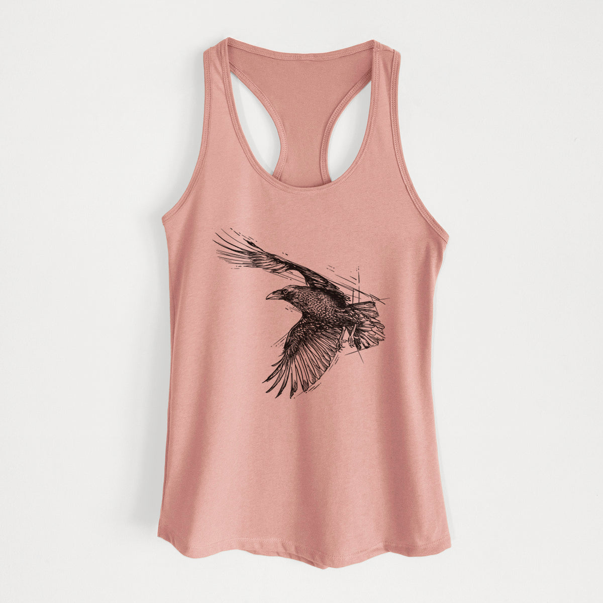 Desert pink women's racerback tank top laid flat, printed with a black ink illustration of a raven in flight with its wings spread.