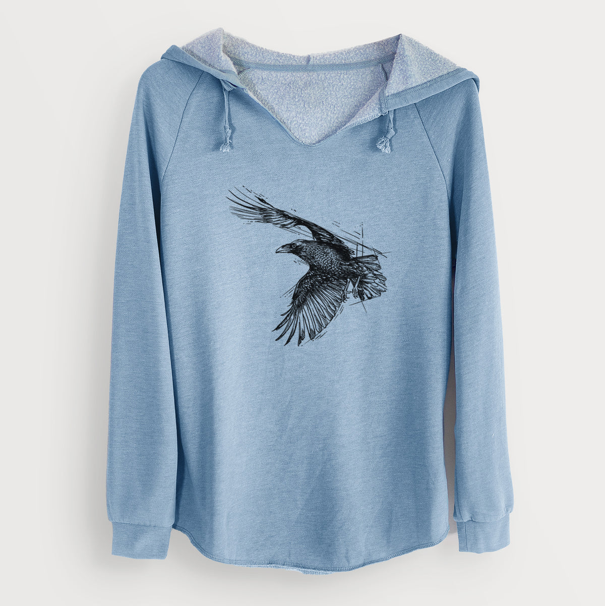 Misty blue women's Cali Wave hooded sweatshirt laid flat, printed with a black ink illustration of a raven in flight with its wings spread.