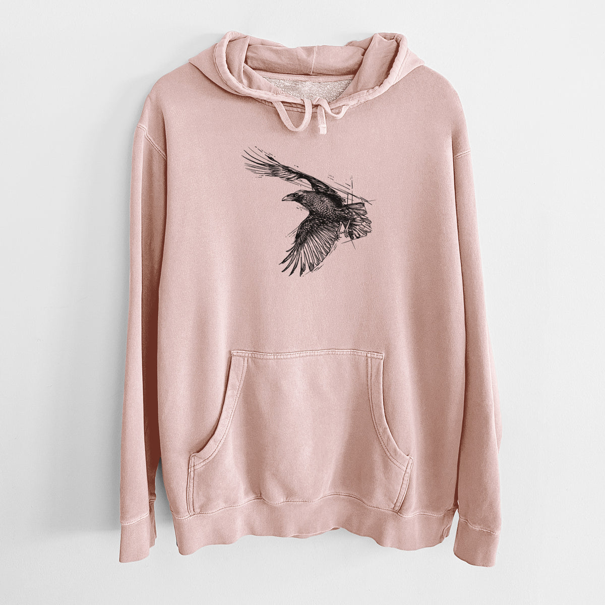 Dusty pink pigment dyed hoodie laid flat, printed with a black ink illustration of a raven in flight with its wings spread.