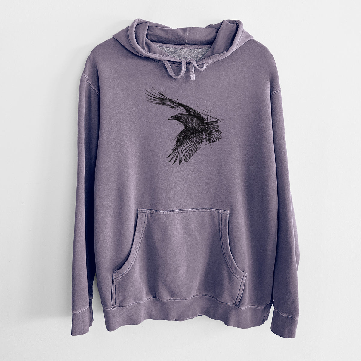 Plum purple pigment dyed hoodie laid flat, printed with a black ink illustration of a raven in flight with its wings spread.
