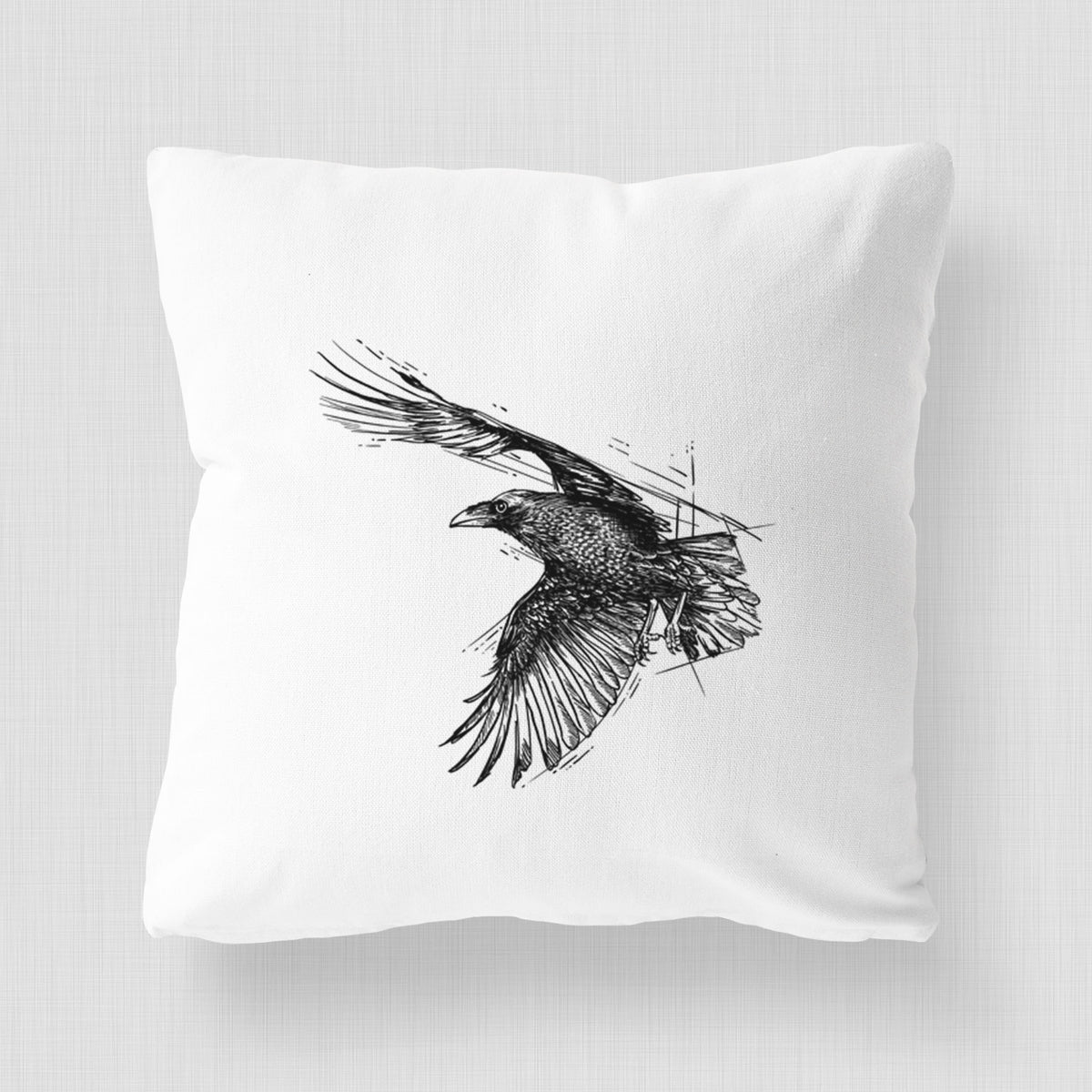 White pillow cover printed with a black ink illustration of a raven in flight with its wings spread.