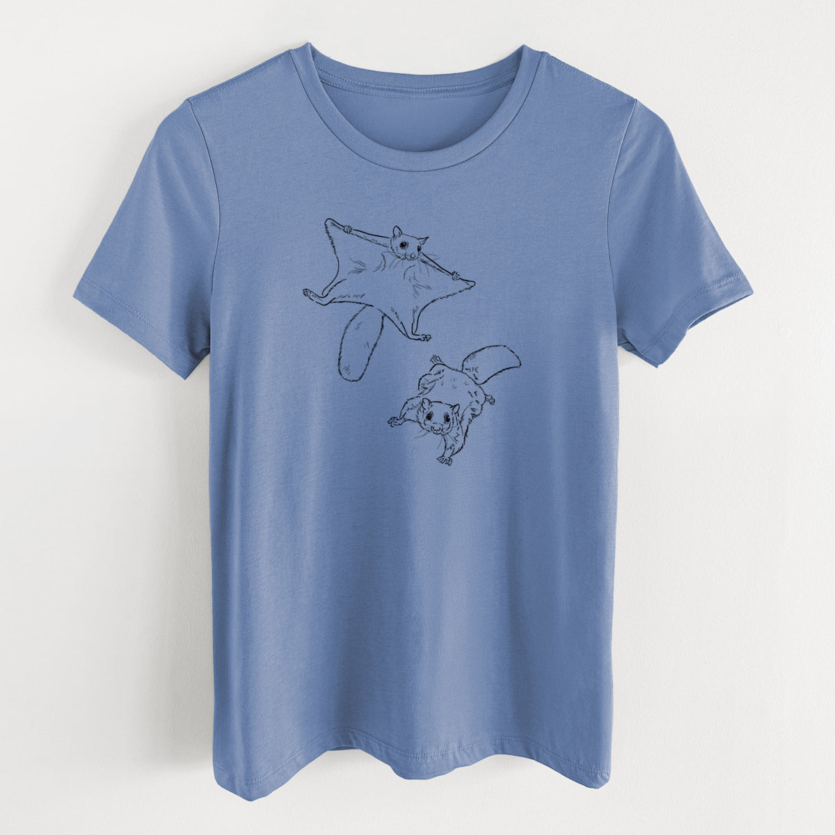 Blue bell women's relaxed fit cotton t-shirt laid flat, printed with a black ink illustration of two flying squirrels gliding with their skin flaps spread.