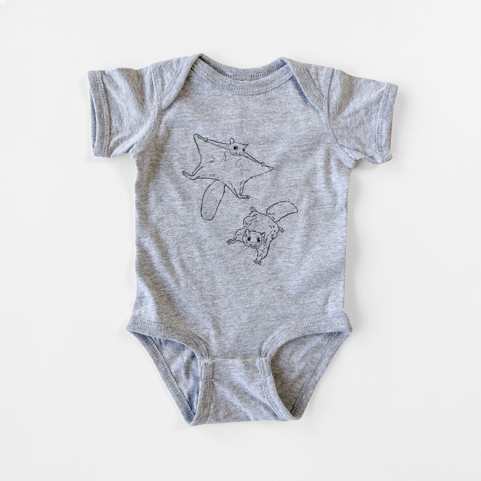 Grey baby bodysuit laid flat, printed with a black ink illustration of two flying squirrels gliding with their skin flaps spread.