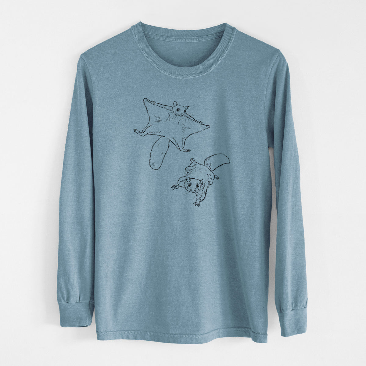 Steel blue Comfort Colors long sleeve shirt laid flat, printed with a black ink illustration of two flying squirrels gliding with their skin flaps spread.