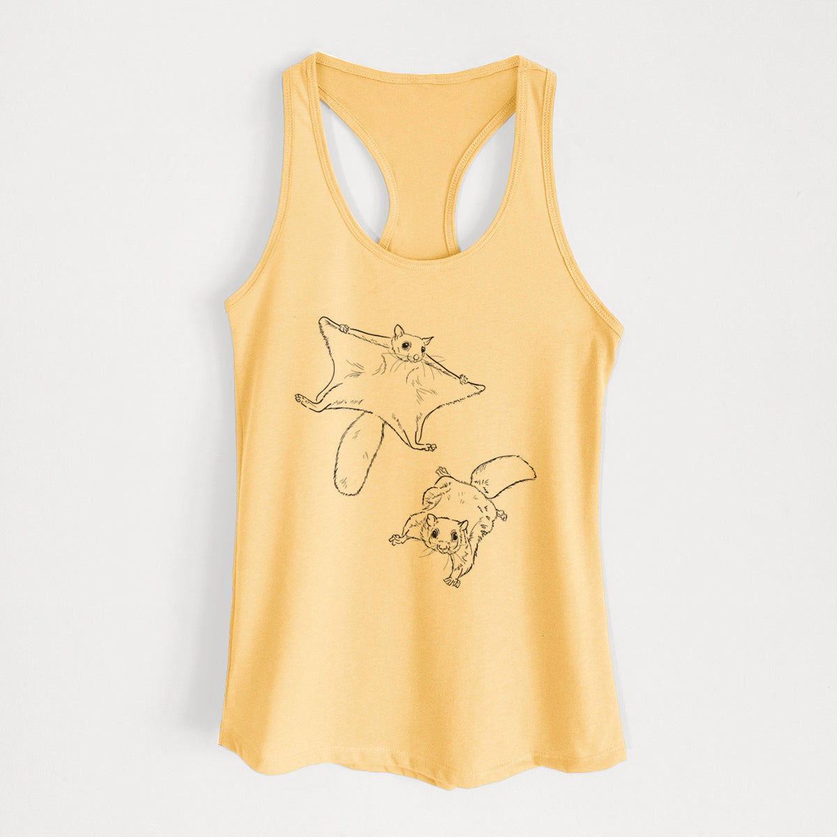 Banana cream women's racerback tank top laid flat, printed with a black ink illustration of two flying squirrels gliding with their skin flaps spread.