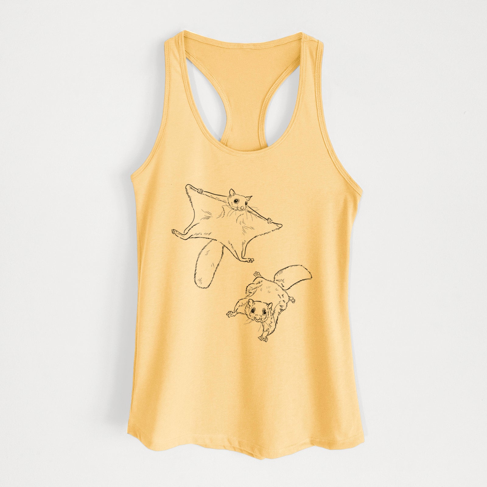 Banana cream women's racerback tank top laid flat, printed with a black ink illustration of two flying squirrels gliding with their skin flaps spread.