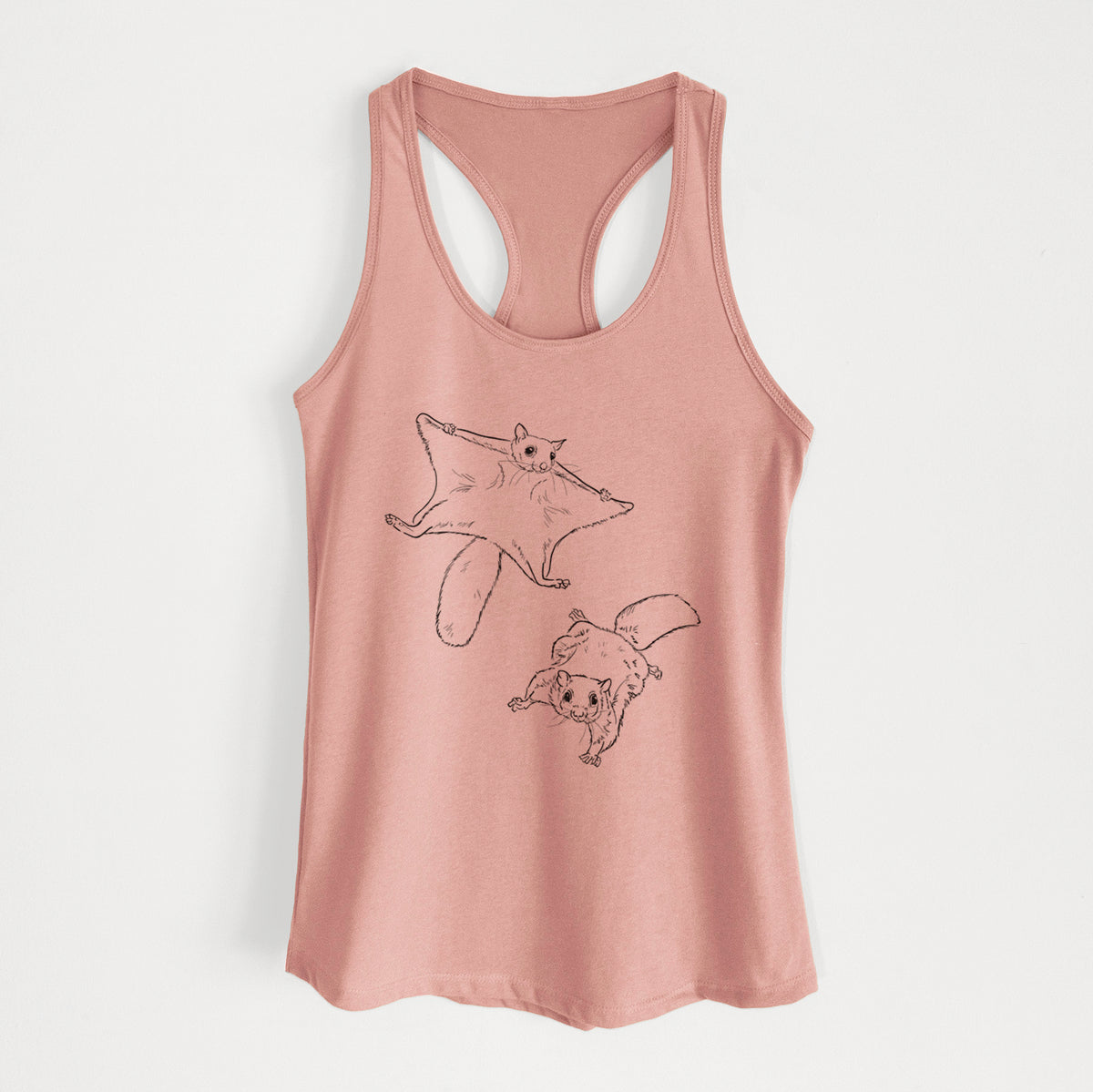 Desert pink women's racerback tank top laid flat, printed with a black ink illustration of two flying squirrels gliding with their skin flaps spread.
