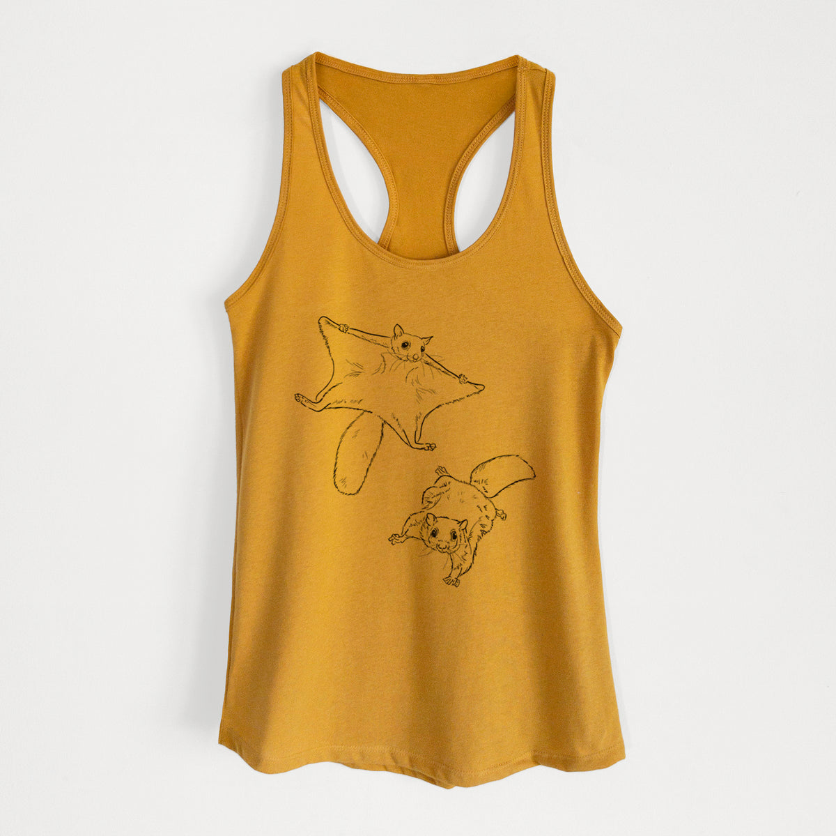 Gold women's racerback tank top laid flat, printed with a black ink illustration of two flying squirrels gliding with their skin flaps spread.