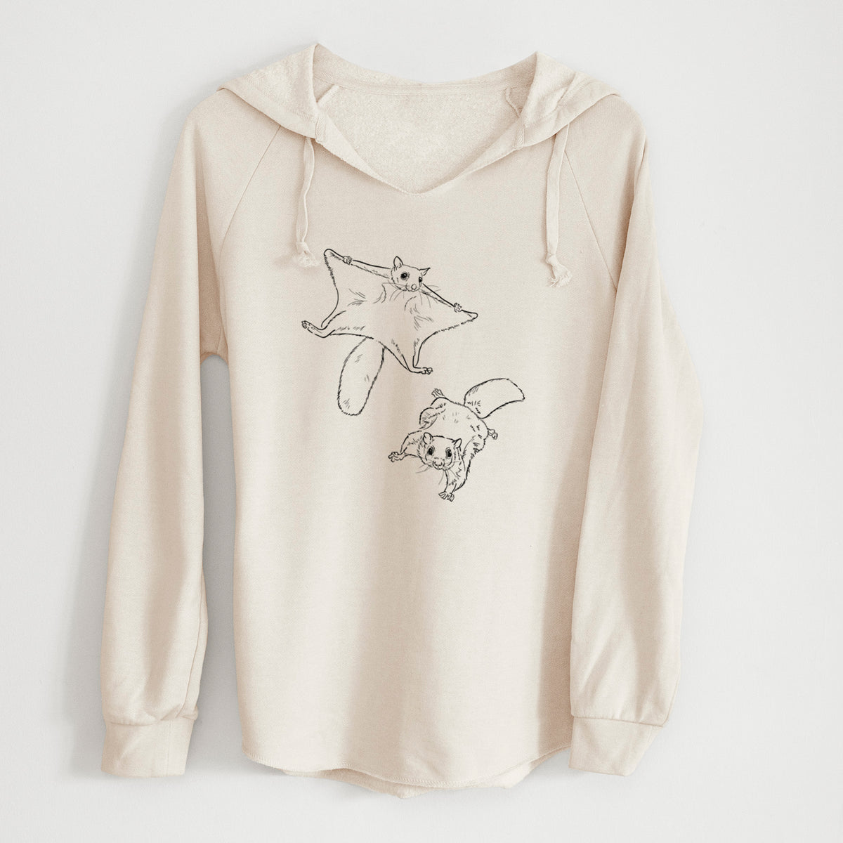 Bone cream women's Cali Wave hooded sweatshirt laid flat, printed with a black ink illustration of two flying squirrels gliding with their skin flaps spread.