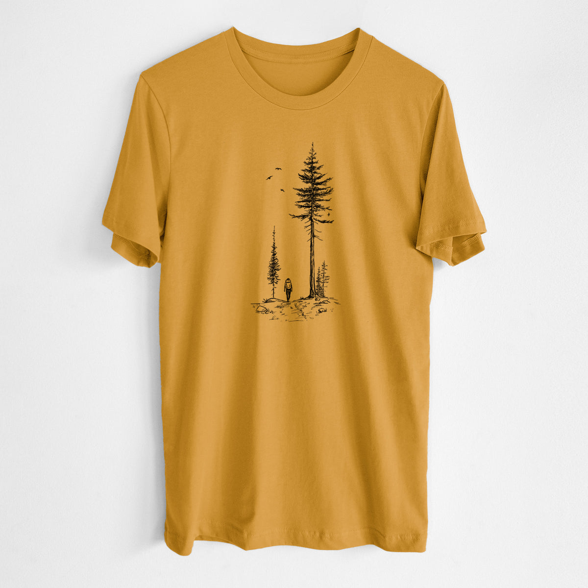 Honeycomb yellow lightweight cotton t-shirt laid flat, printed with a black ink illustration of a lone hiker walking between tall pine trees with birds overhead.