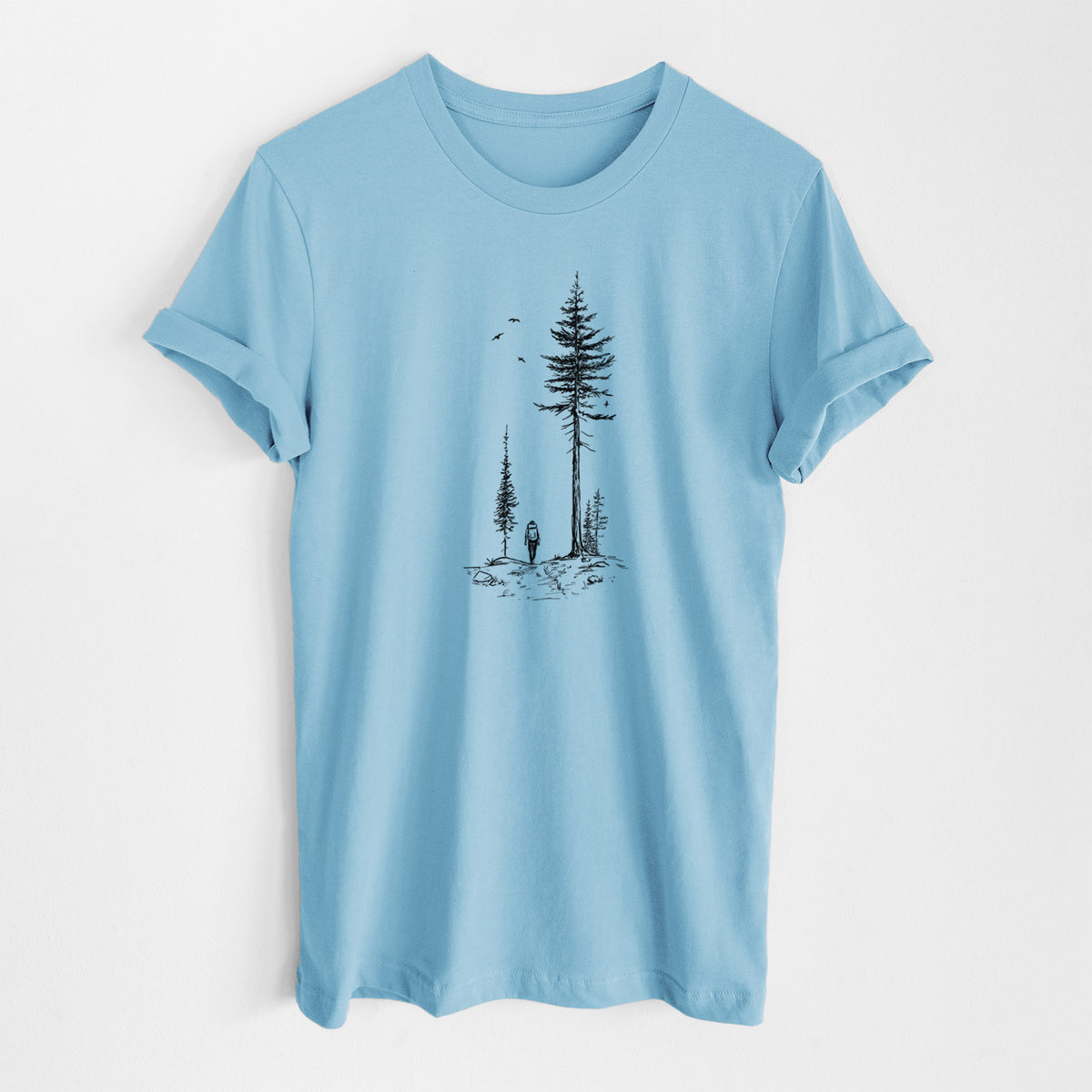 Ocean blue lightweight cotton t-shirt laid flat, printed with a black ink illustration of a lone hiker walking between tall pine trees with birds overhead.