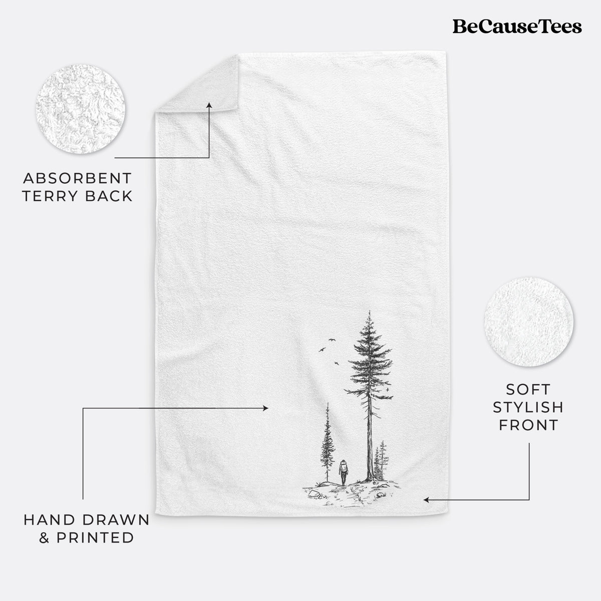 White hand towel printed with a black ink illustration of a lone hiker walking between tall pine trees with birds overhead.