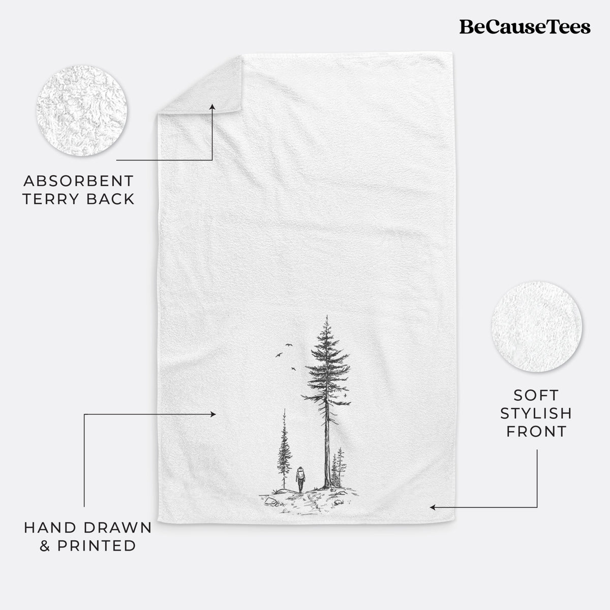 White hand towel printed with a black ink illustration of a lone hiker walking between tall pine trees with birds overhead.