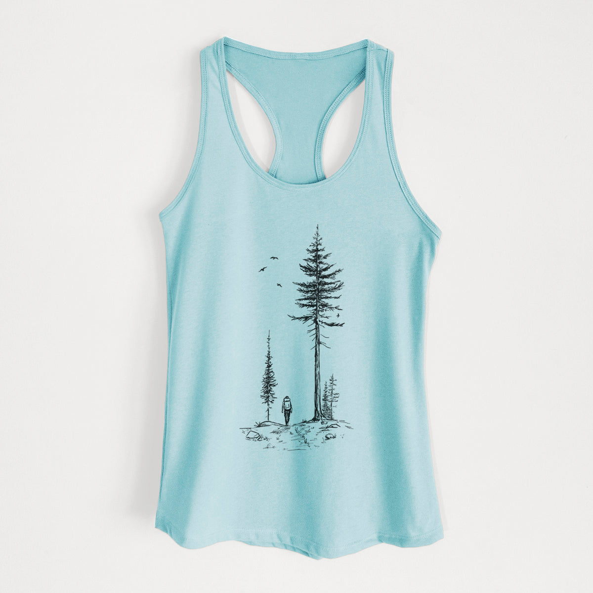 Cancun blue women's racerback tank top laid flat, printed with a black ink illustration of a lone hiker walking between tall pine trees with birds overhead.