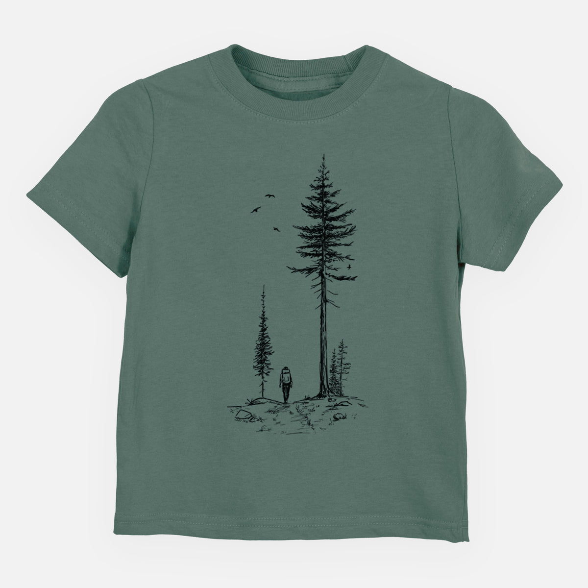 Basil green toddler t-shirt laid flat, printed with a black ink illustration of a lone hiker walking between tall pine trees with birds overhead.