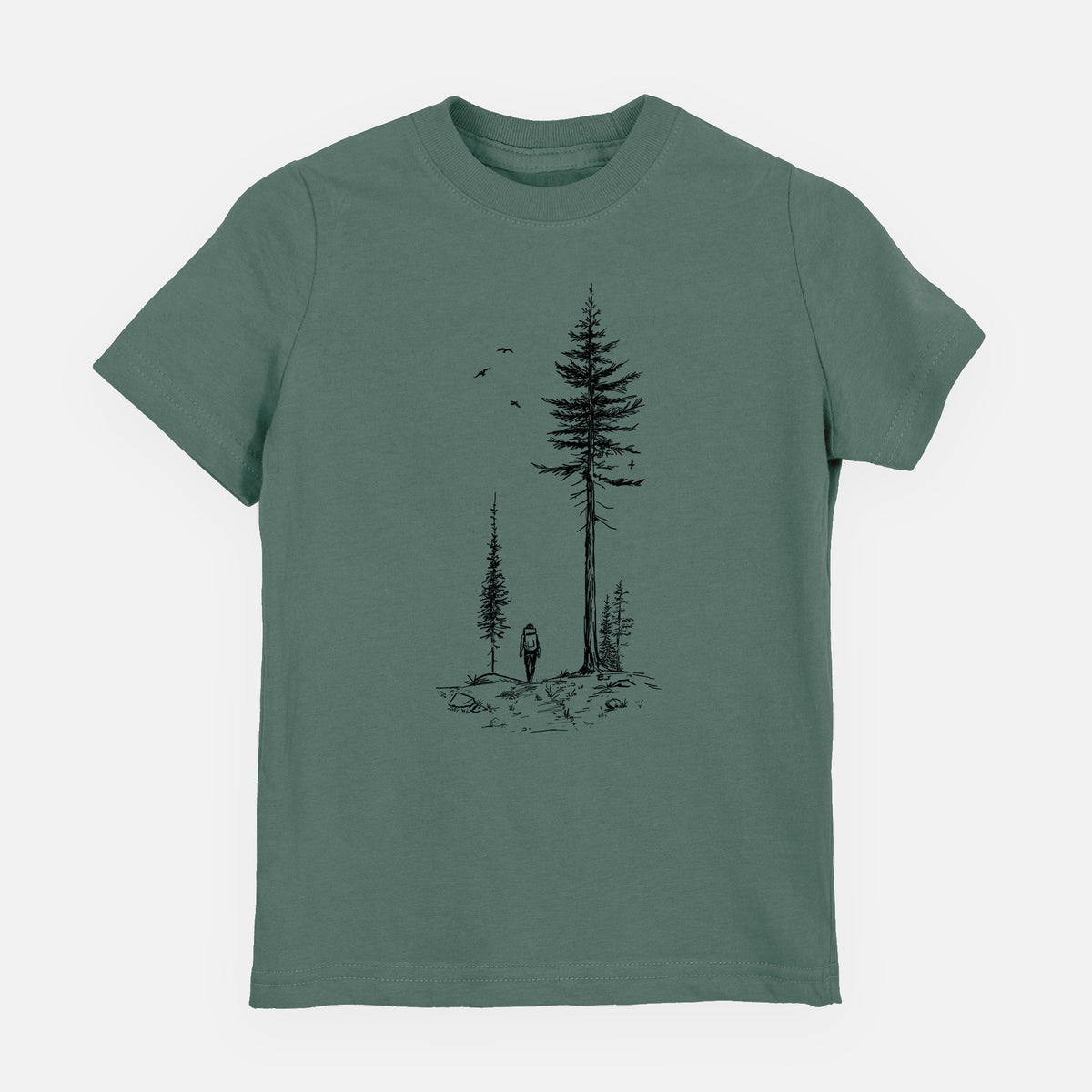 Basil green youth t-shirt laid flat, printed with a black ink illustration of a lone hiker walking between tall pine trees with birds overhead.