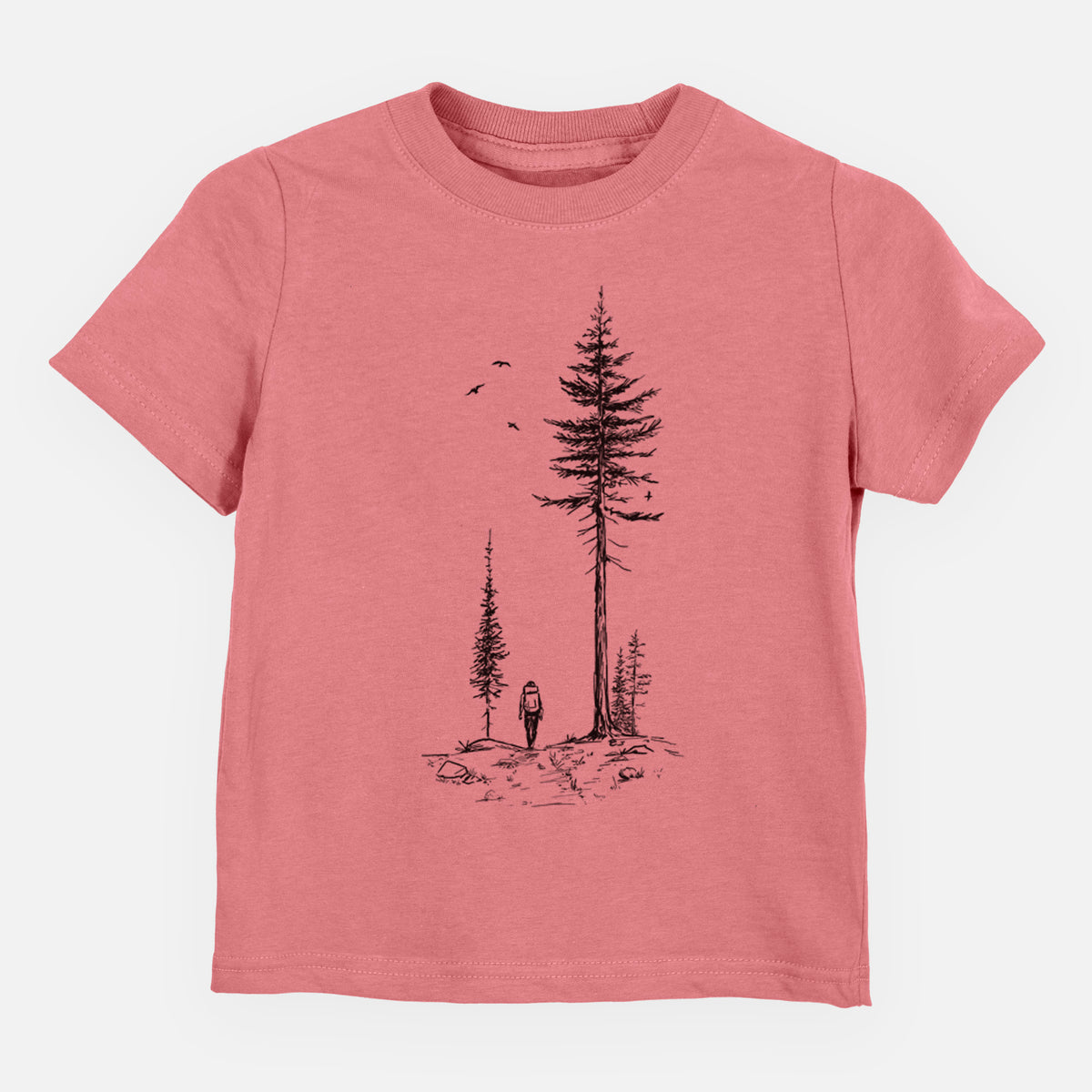 Mauve pink toddler t-shirt laid flat, printed with a black ink illustration of a lone hiker walking between tall pine trees with birds overhead.