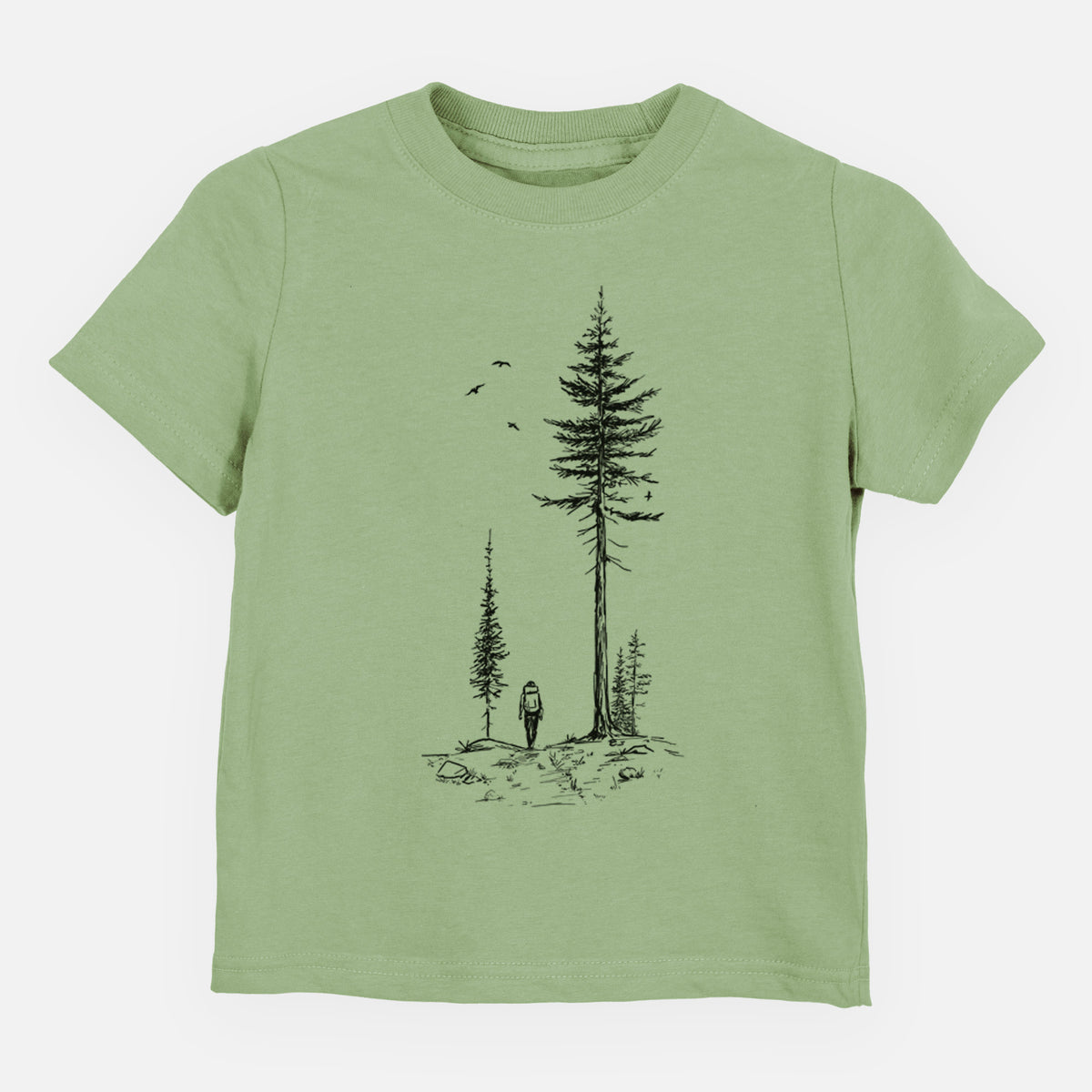 Sage green toddler t-shirt laid flat, printed with a black ink illustration of a lone hiker walking between tall pine trees with birds overhead.