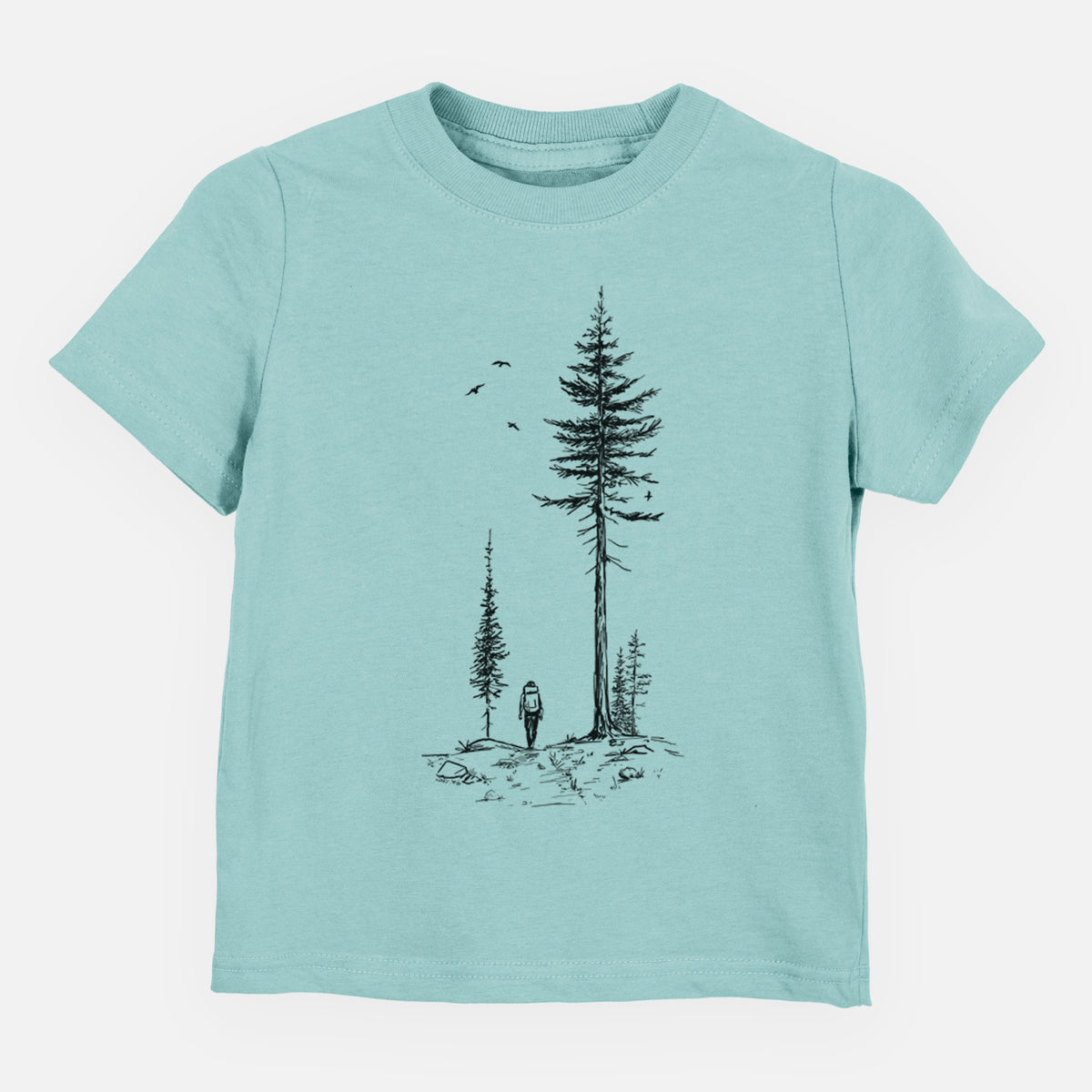 Saltwater toddler t-shirt laid flat, printed with a black ink illustration of a lone hiker walking between tall pine trees with birds overhead.