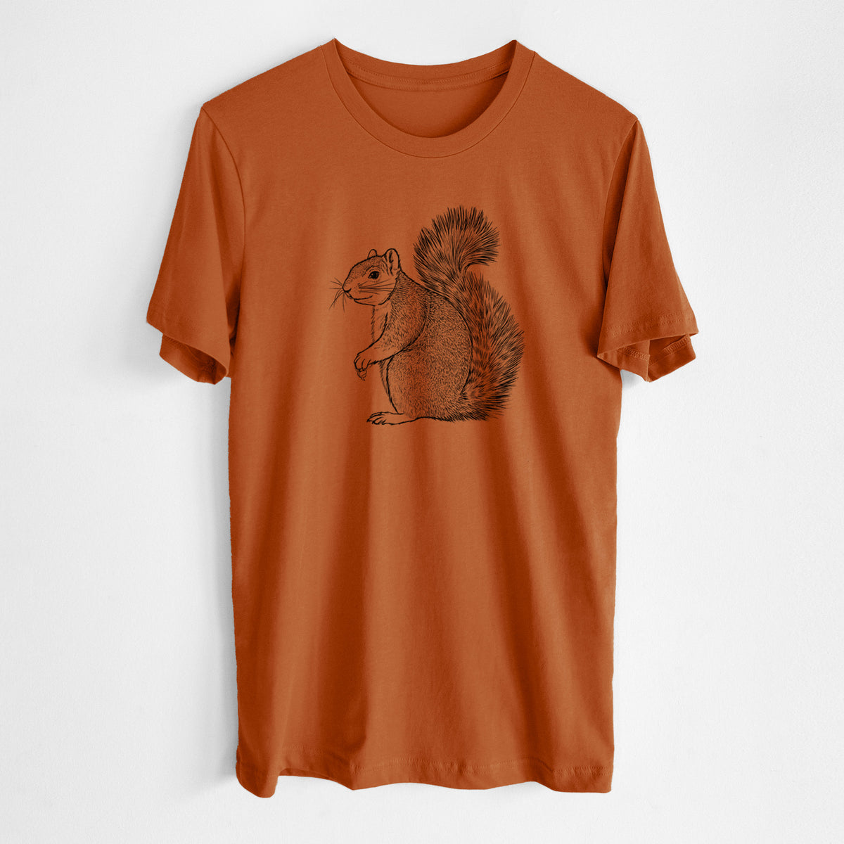 Autumn lightweight cotton t-shirt laid flat, printed with a detailed black ink illustration of a fox squirrel sitting with a bushy tail.