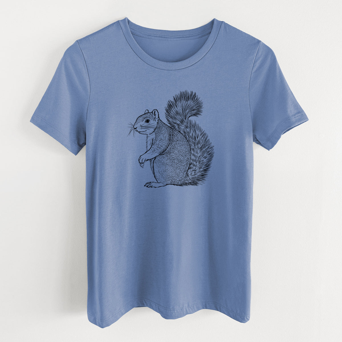 Blue bell women's relaxed fit cotton t-shirt laid flat, printed with a detailed black ink illustration of a fox squirrel sitting with a bushy tail.
