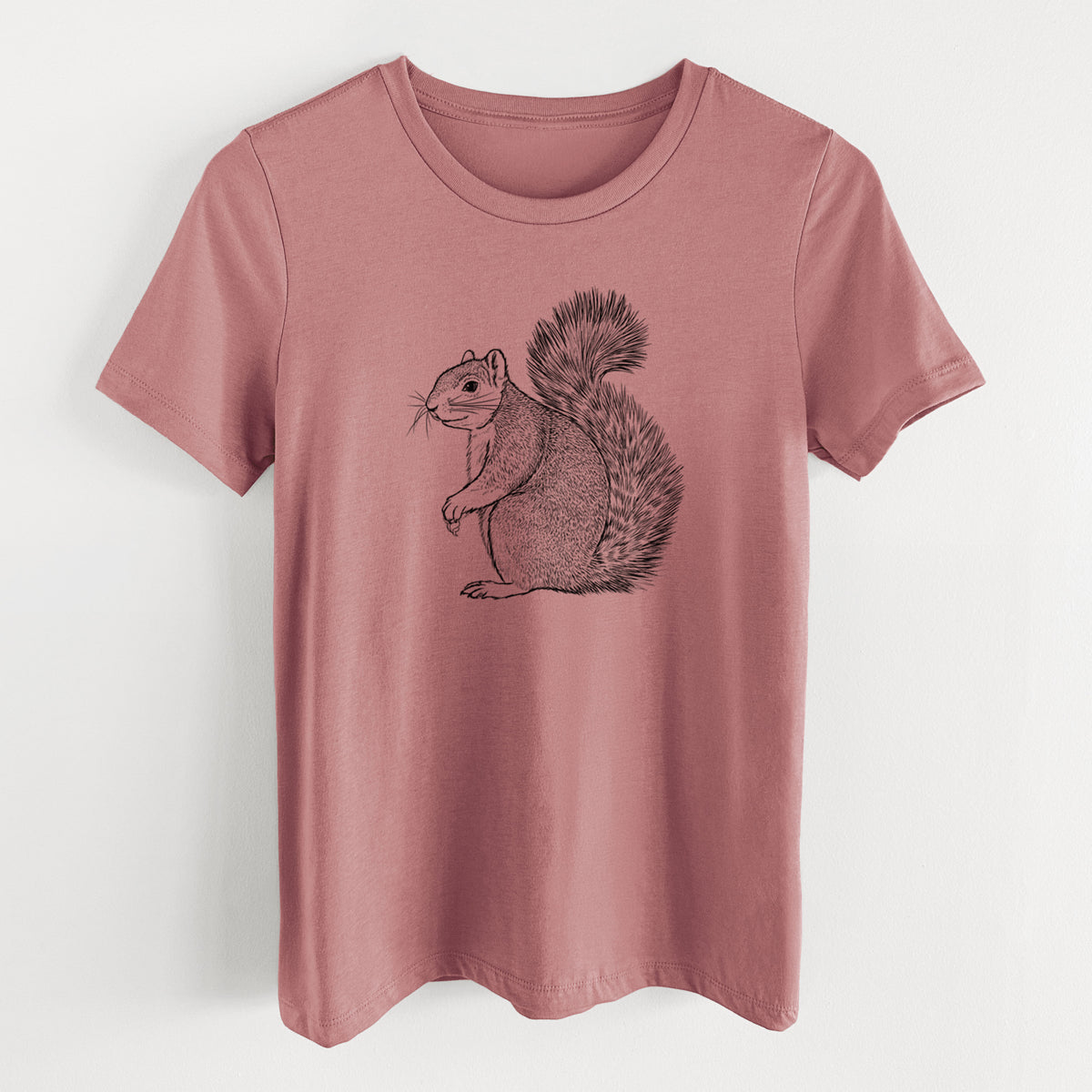 Mauve pink women's relaxed fit cotton t-shirt laid flat, printed with a detailed black ink illustration of a fox squirrel sitting with a bushy tail.