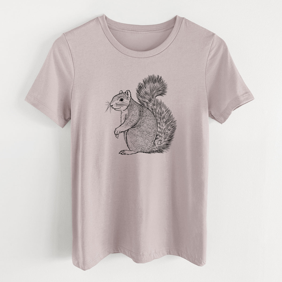 Pink gravel women's relaxed fit cotton t-shirt laid flat, printed with a detailed black ink illustration of a fox squirrel sitting with a bushy tail.