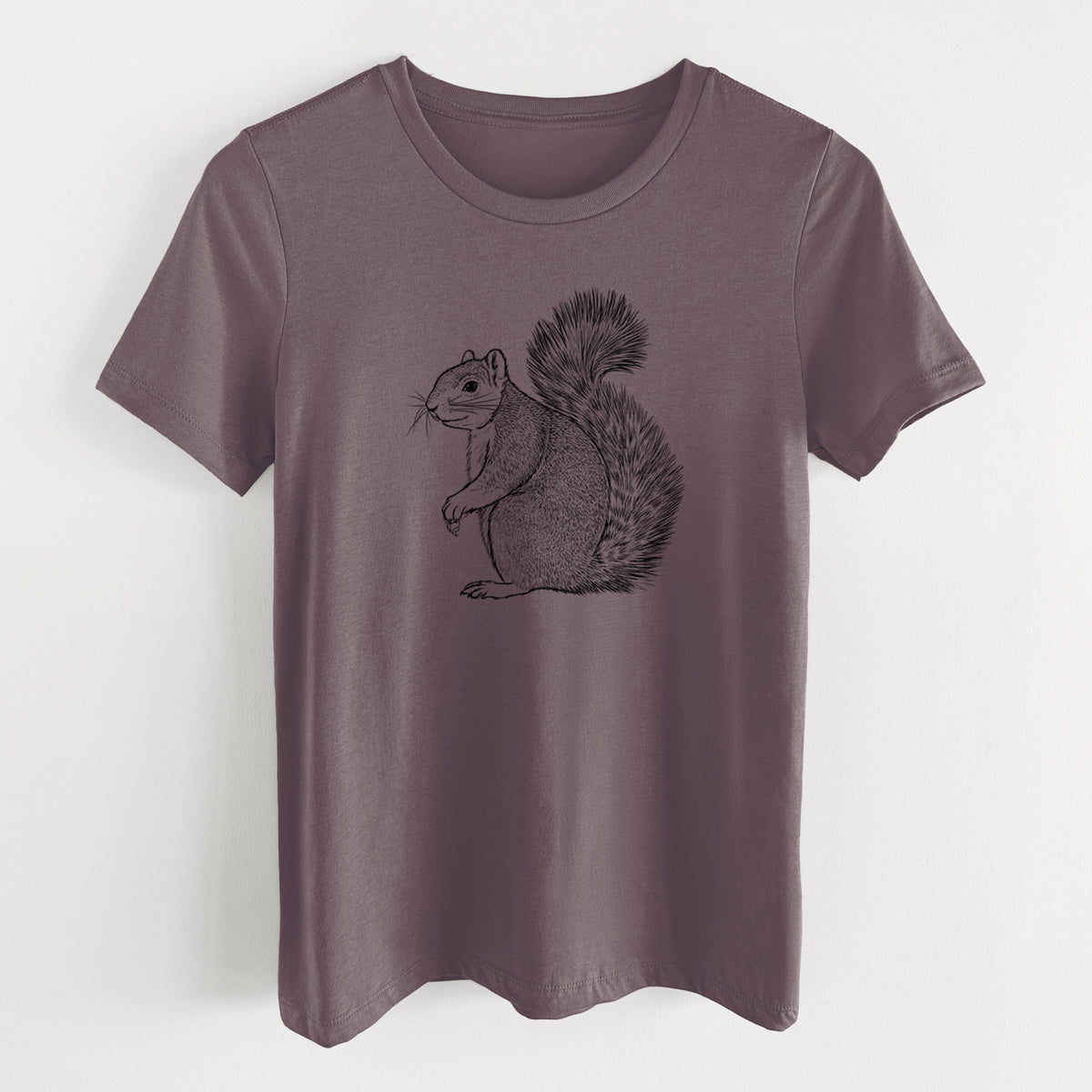 Purple storm women's relaxed fit cotton t-shirt laid flat, printed with a detailed black ink illustration of a fox squirrel sitting with a bushy tail.