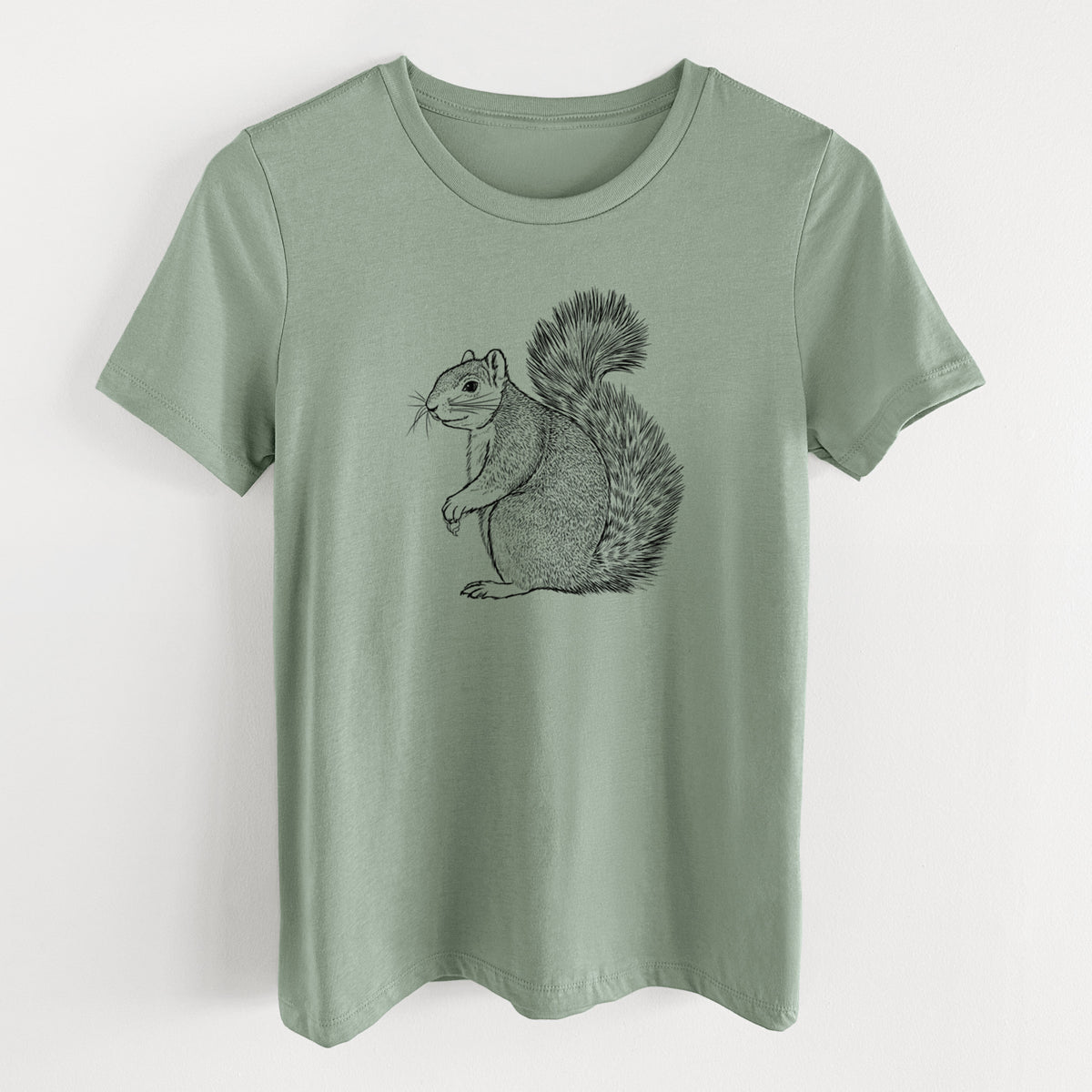 Sage green women's relaxed fit cotton t-shirt laid flat, printed with a detailed black ink illustration of a fox squirrel sitting with a bushy tail.