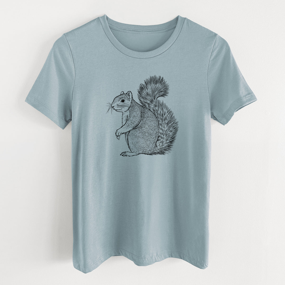 Vintage denim women's relaxed fit cotton t-shirt laid flat, printed with a detailed black ink illustration of a fox squirrel sitting with a bushy tail.
