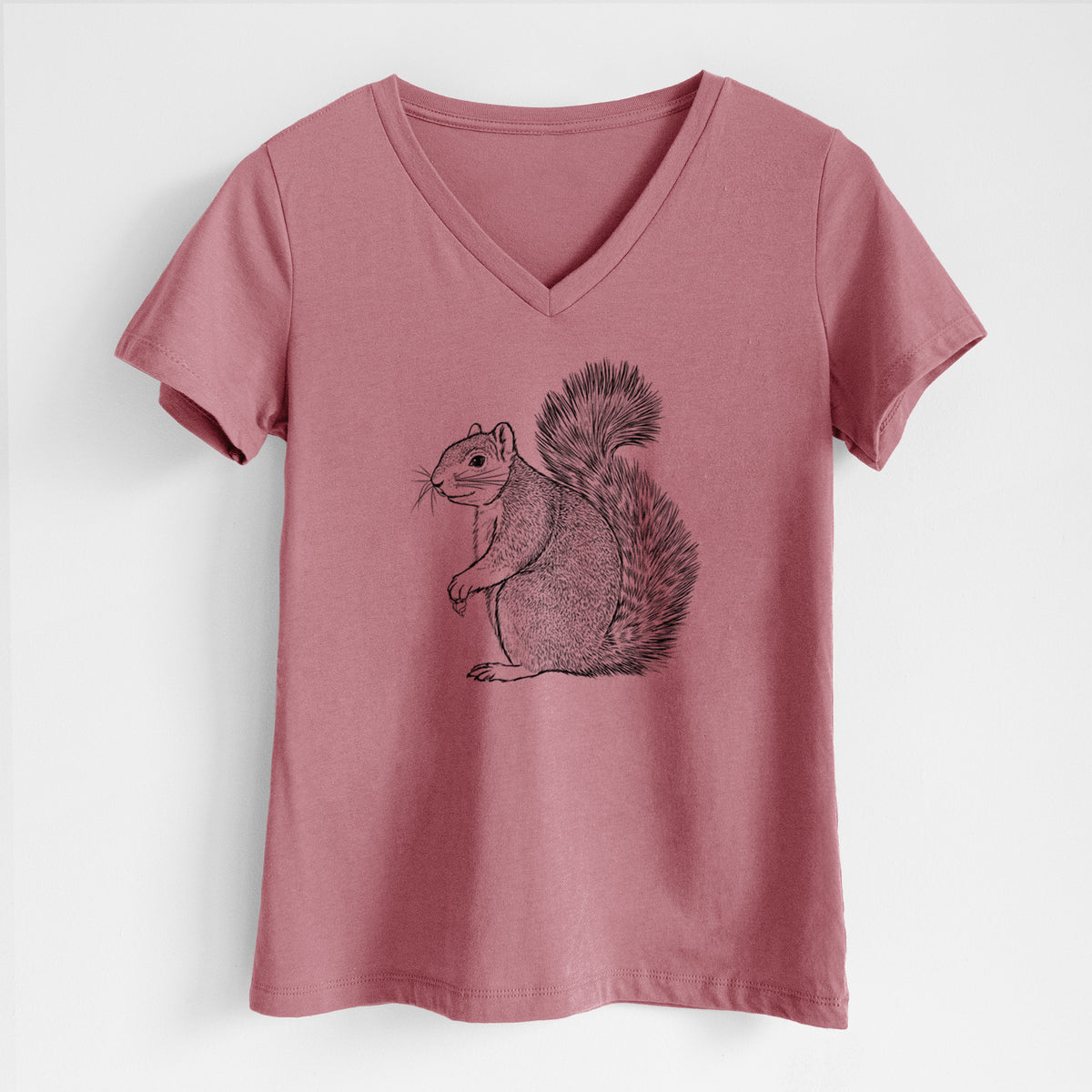 Mauve pink women's relaxed fit cotton V-neck t-shirt laid flat, printed with a detailed black ink illustration of a fox squirrel sitting with a bushy tail.