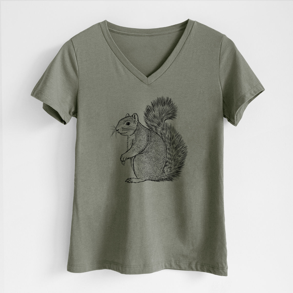 Military green women's relaxed fit cotton V-neck t-shirt laid flat, printed with a detailed black ink illustration of a fox squirrel sitting with a bushy tail.
