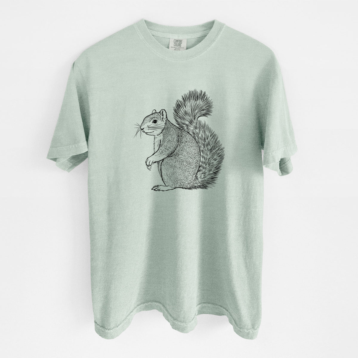 Bay green Comfort Colors t-shirt laid flat, printed with a detailed black ink illustration of a fox squirrel sitting with a bushy tail.
