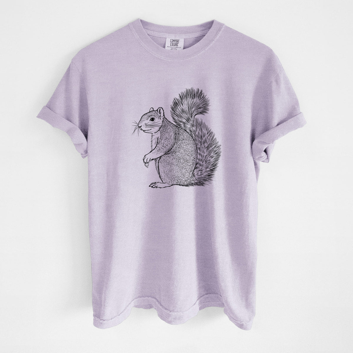 Orchid purple Comfort Colors t-shirt laid flat, printed with a detailed black ink illustration of a fox squirrel sitting with a bushy tail.