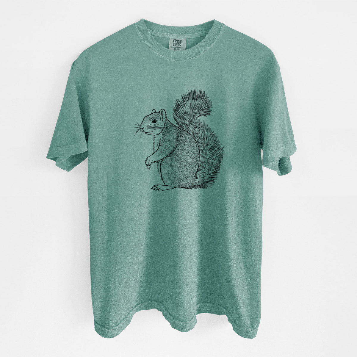 Reef green Comfort Colors t-shirt laid flat, printed with a detailed black ink illustration of a fox squirrel sitting with a bushy tail.