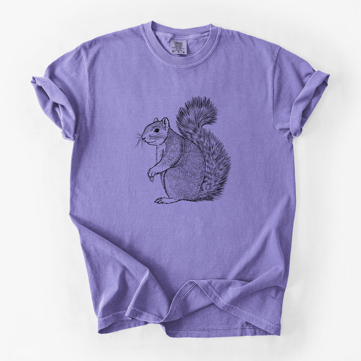 Violet purple Comfort Colors t-shirt laid flat, printed with a detailed black ink illustration of a fox squirrel sitting with a bushy tail.