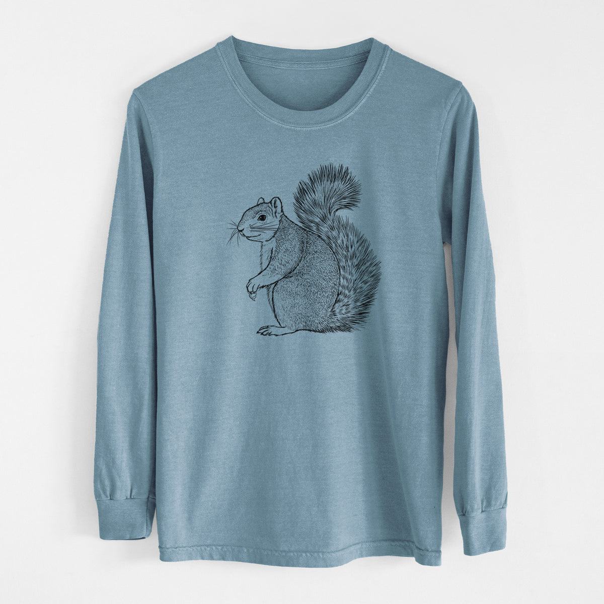 Steel blue Comfort Colors long sleeve shirt laid flat, printed with a detailed black ink illustration of a fox squirrel sitting with a bushy tail.