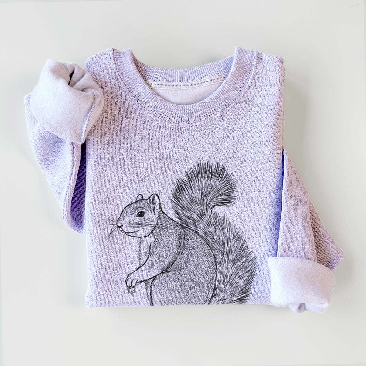 Ice purple knit sweatshirt printed with a detailed black ink illustration of a fox squirrel sitting with a bushy tail, styled flat.