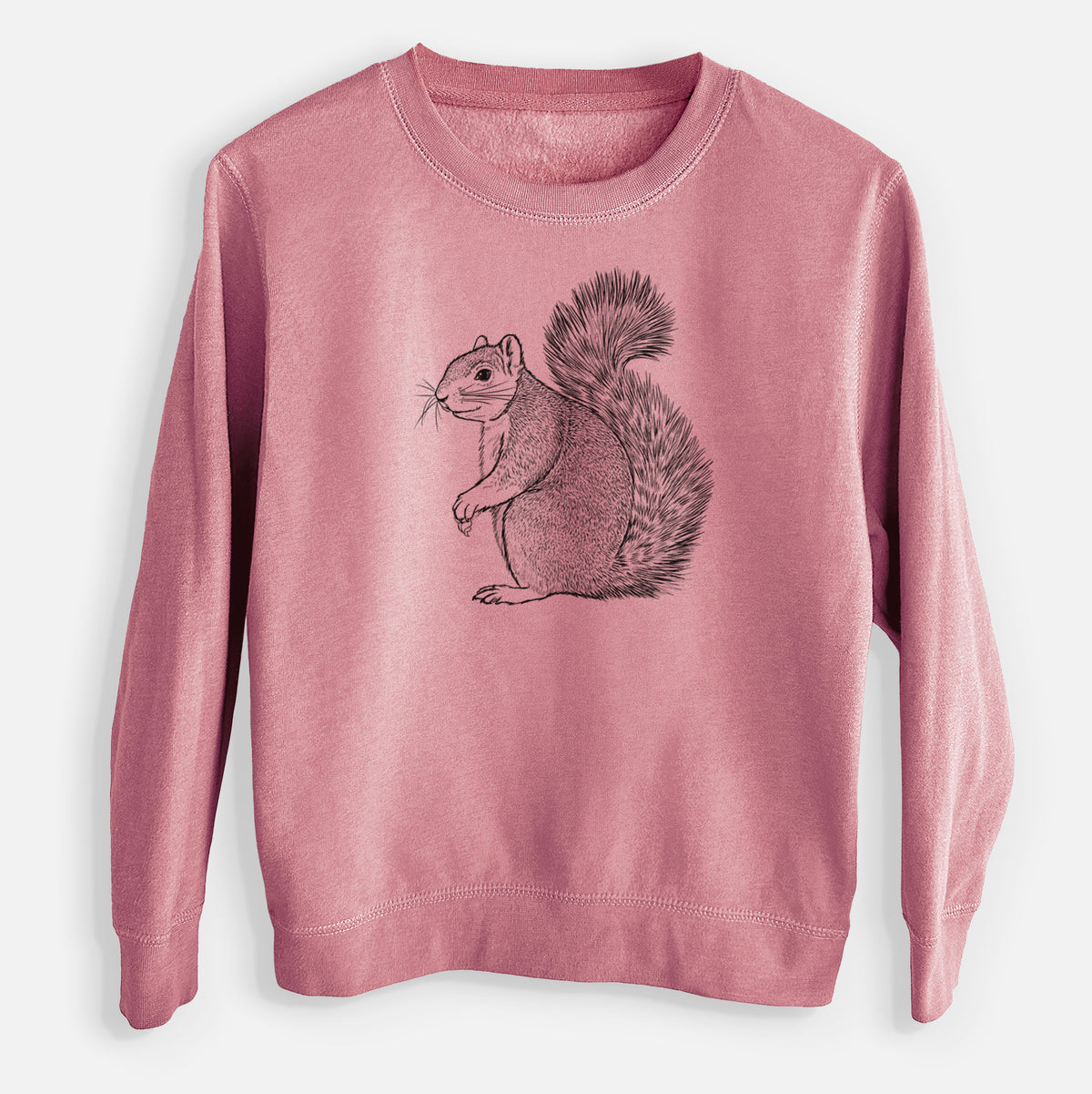 Mauve pink youth crewneck sweatshirt laid flat, printed with a detailed black ink illustration of a fox squirrel sitting with a bushy tail.