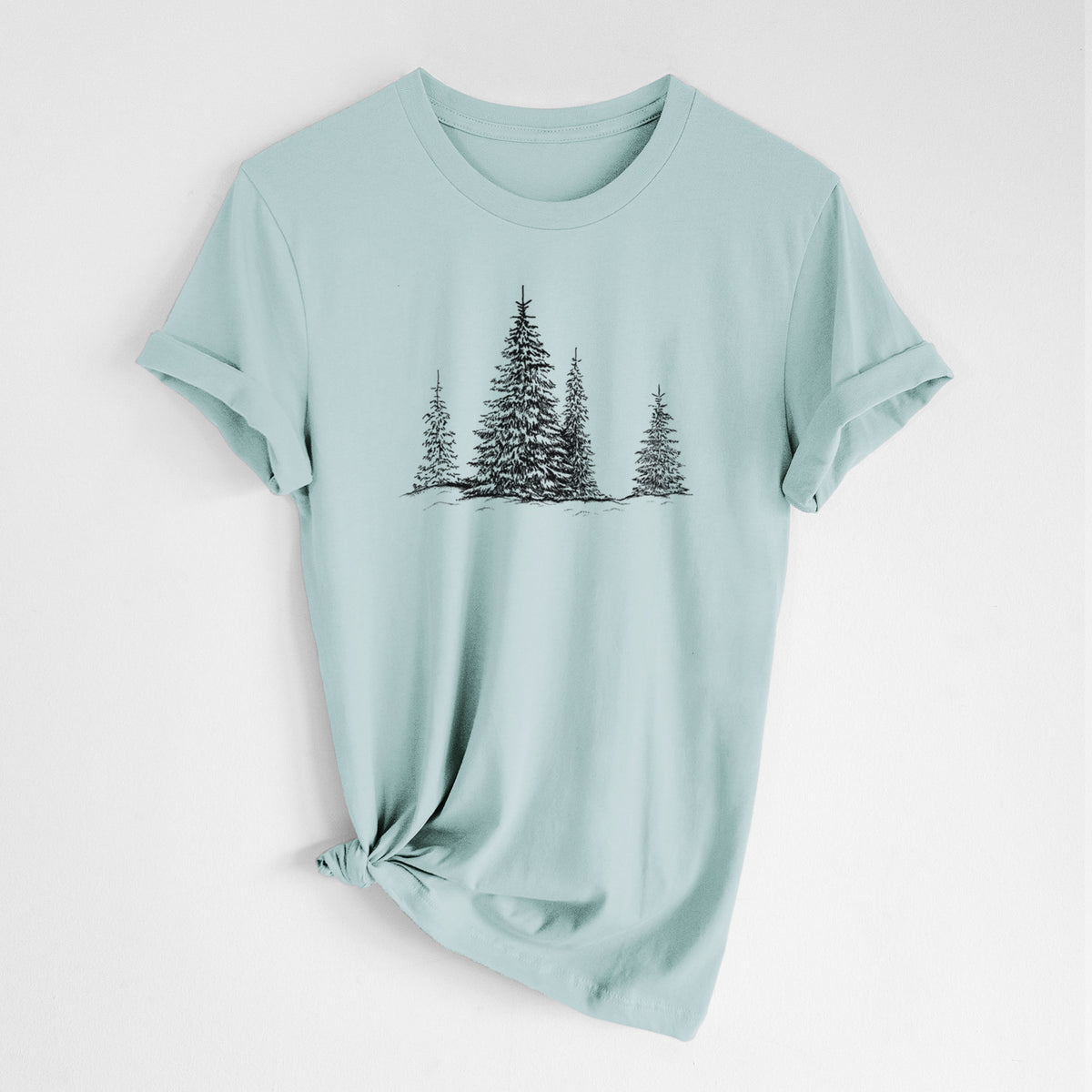 Dusty blue lightweight cotton t-shirt laid flat with the sleeves rolled, printed with a black ink illustration of frost-covered evergreen trees.