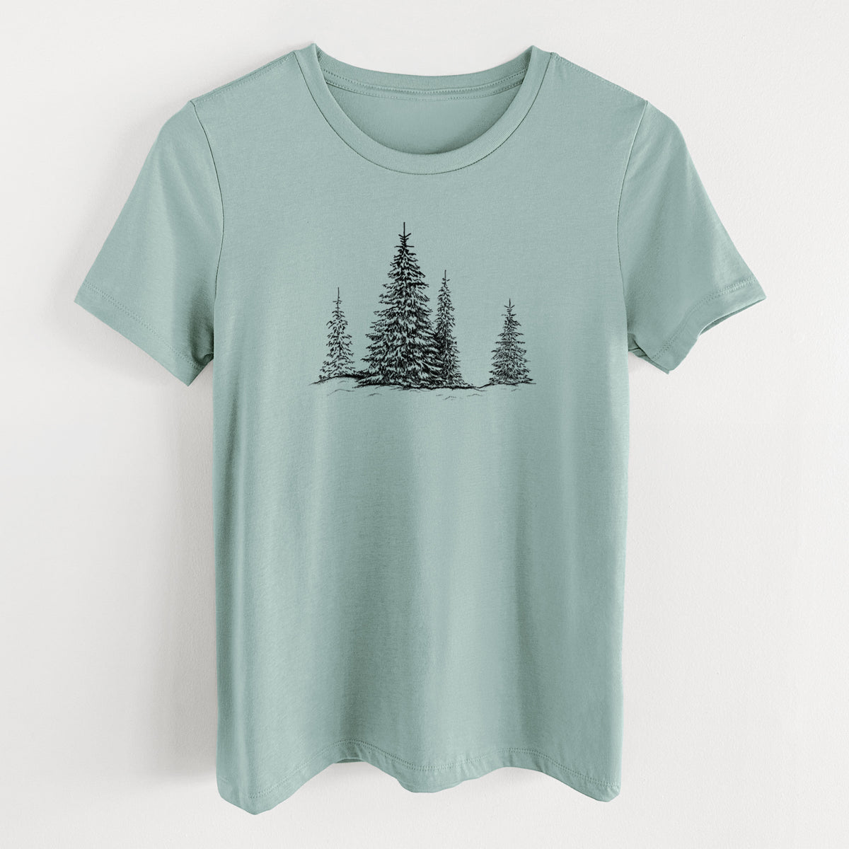 Dusty blue women's relaxed fit cotton t-shirt laid flat, printed with a black ink illustration of frost-covered evergreen trees.