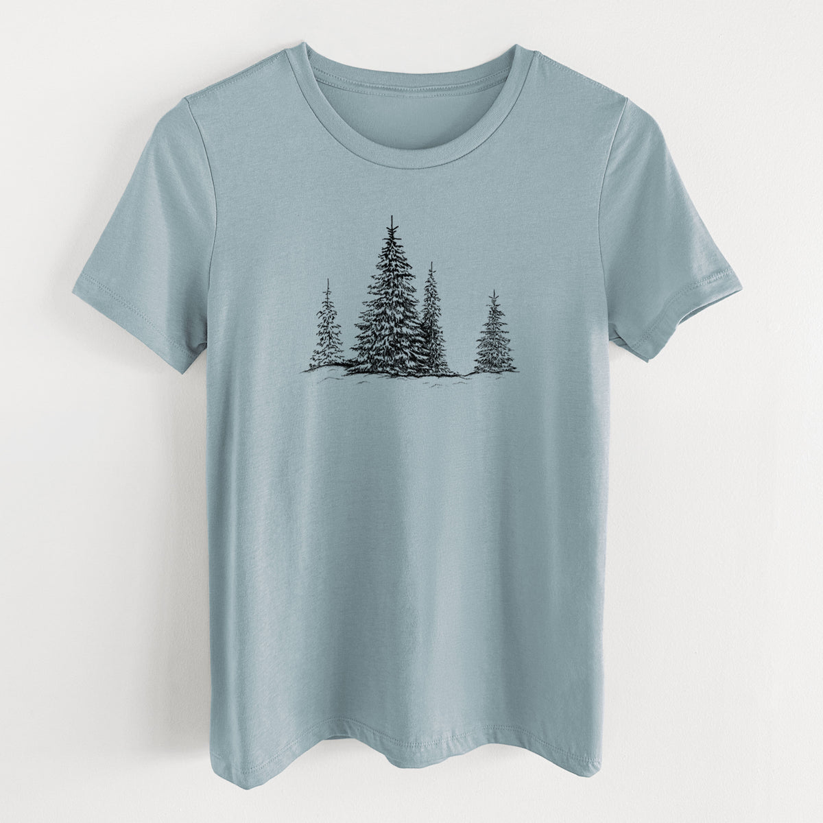 Vintage denim women's relaxed fit cotton t-shirt laid flat, printed with a black ink illustration of frost-covered evergreen trees.