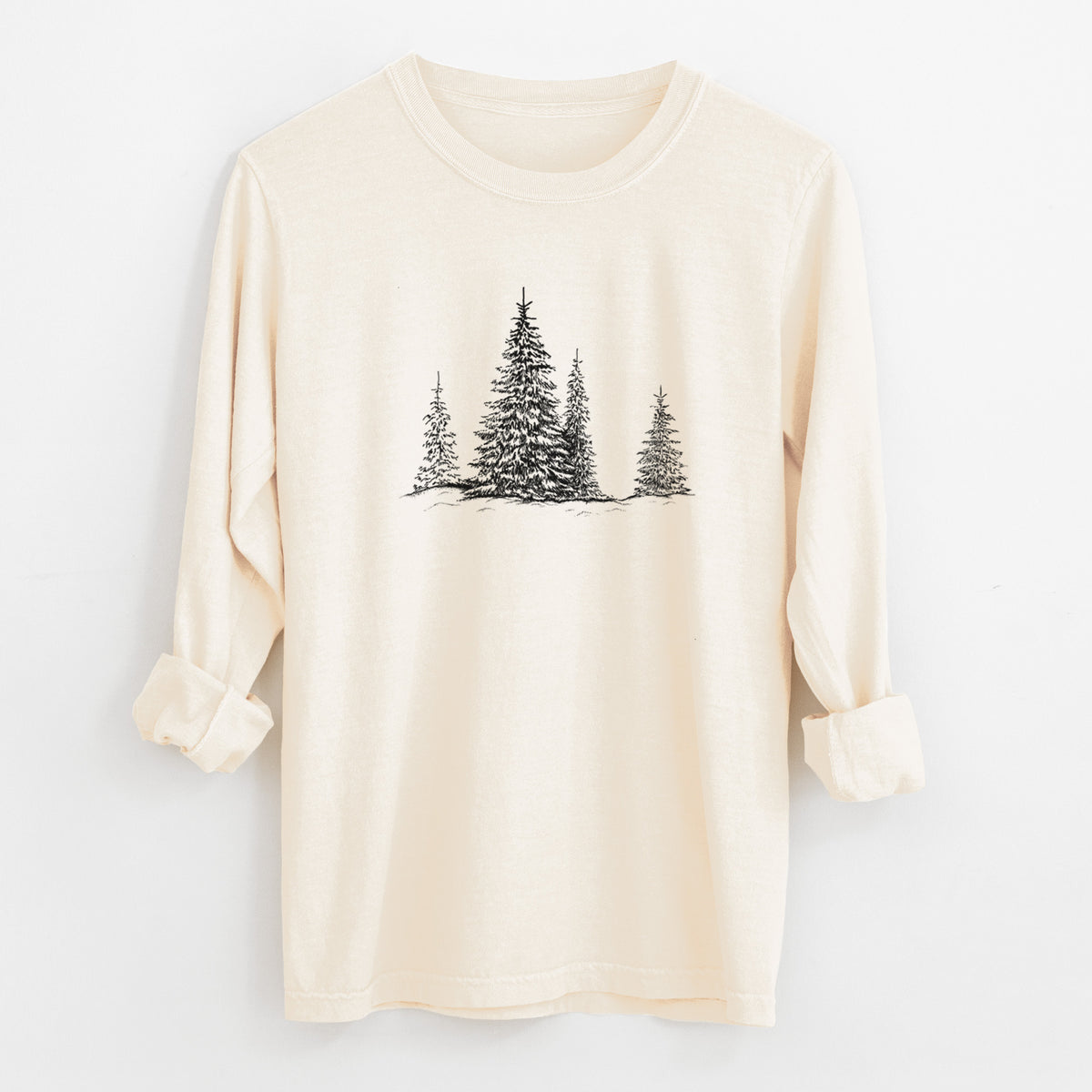 Ivory Comfort Colors long sleeve shirt laid flat with the cuffs rolled, printed with a black ink illustration of frost-covered evergreen trees.