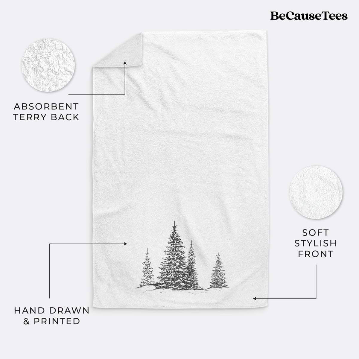 White hand towel printed with a black ink illustration of frost-covered evergreen trees.
