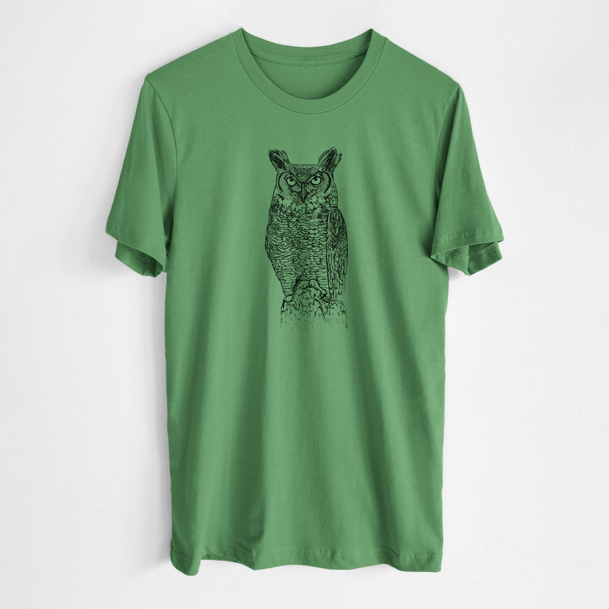 Leaf green lightweight cotton t-shirt laid flat, printed with a detailed black ink illustration of a great horned owl standing upright with its ear tufts raised.