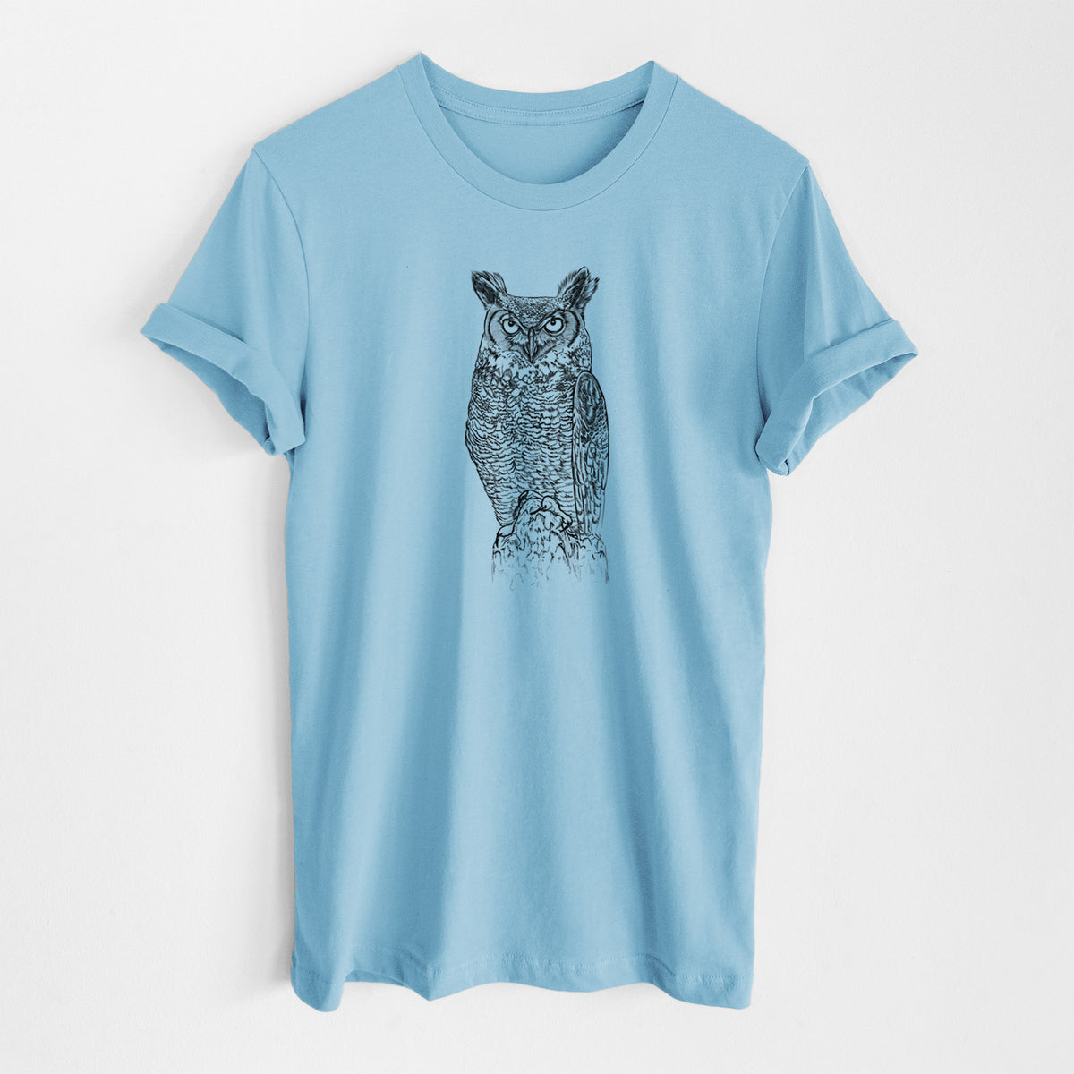 Ocean blue lightweight cotton t-shirt laid flat, printed with a detailed black ink illustration of a great horned owl standing upright with its ear tufts raised.