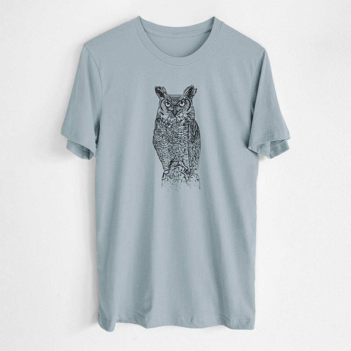 Vintage denim lightweight cotton t-shirt laid flat, printed with a detailed black ink illustration of a great horned owl standing upright with its ear tufts raised.