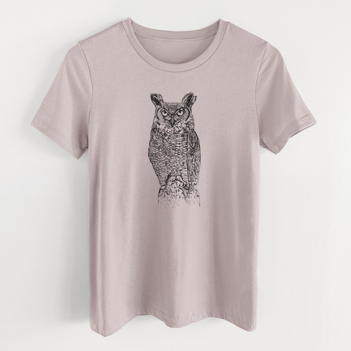Pink gravel women's relaxed fit cotton t-shirt laid flat, printed with a detailed black ink illustration of a great horned owl standing upright with its ear tufts raised.