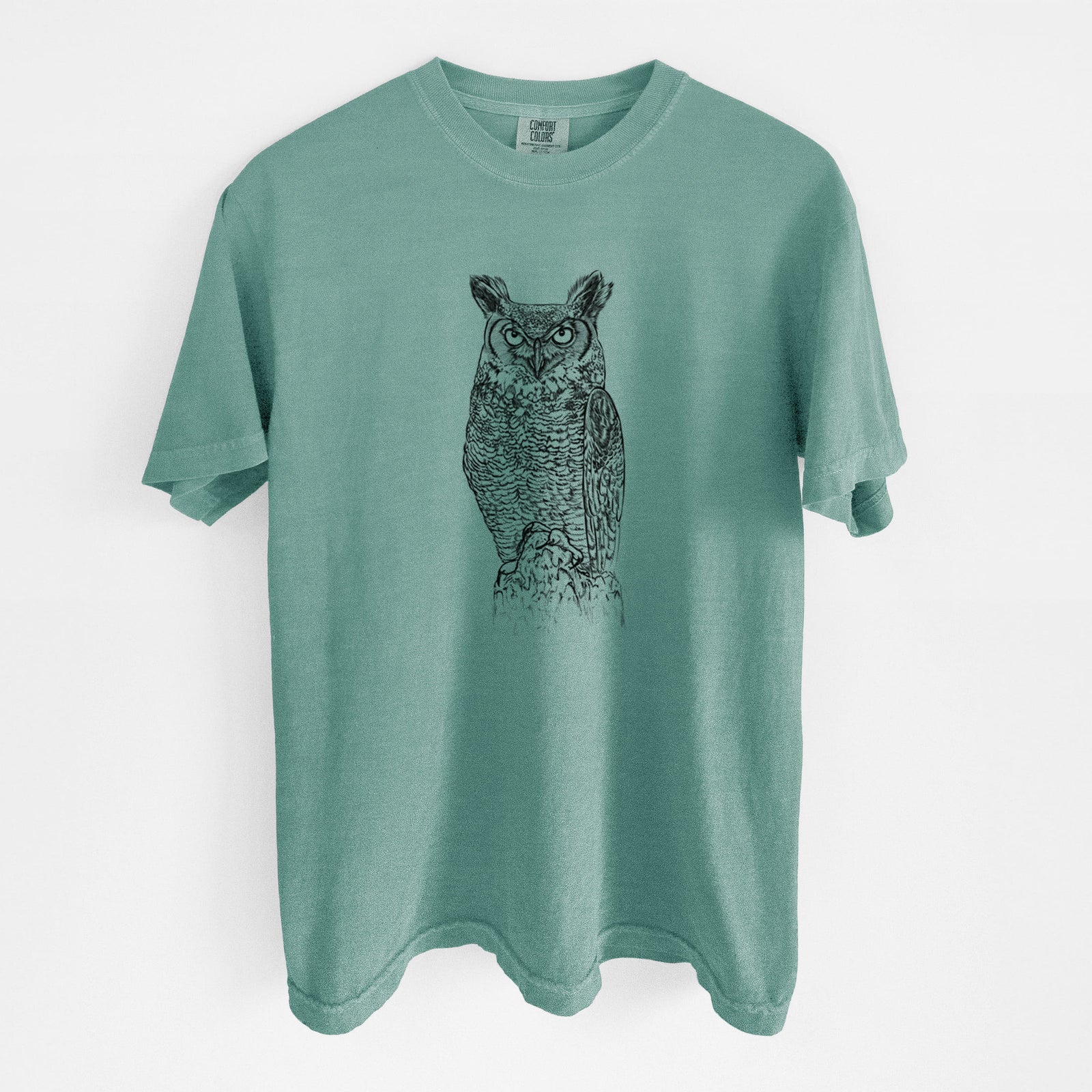 Blue jean Comfort Colors t-shirt laid flat, printed with a detailed black ink illustration of a great horned owl standing upright with its ear tufts raised.