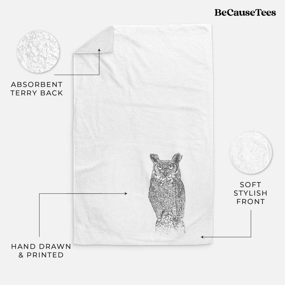 White hand towel printed with a detailed black ink illustration of a great horned owl standing upright with its ear tufts raised.
